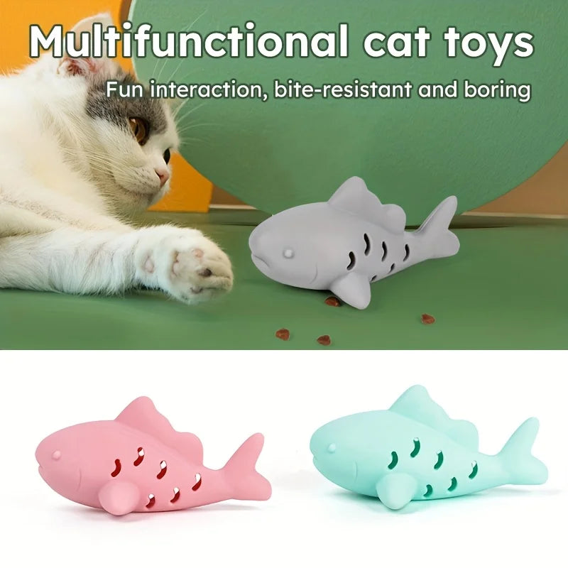 A playful cat interacting with interactive treat dispenser toy shark feeder, featuring bite-resistant design and fun colors.