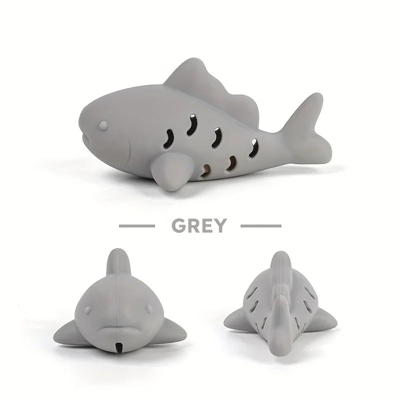 Interactive treat dispenser toy shaped like a shark in grey, designed for pets to challenge and entertain.